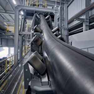 Pipe conveyor belt for enclosed bulk material transportation in a confined industrial area